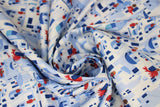 Swirled swatch Santorini fabric (stacked/collaged grecian style houses in white and blue allover with red plant accents)