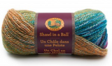 A ball of Lion Brand Shawl in a Ball yarn on white background in shade prism (orange, green, teal, purple colourway twisted yarn with metallic look shimmer)