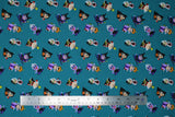 Flat swatch Villains Gather fabric (teal fabric with tossed cartoon disney villains (female) in stubby pop figure style size allover)