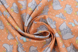 Swirled swatch peach fabric (peach orange fabric with white dots allover and tossed coloured dumbo cartoon characters in various poses allover)