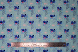 Flat swatch swatch Ohana fabric (light blue fabric with repeated "Ohana" text design with definition and posing stitch character beside)