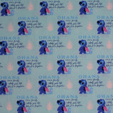 Square swatch Ohana fabric (light blue fabric with repeated "Ohana" text design with definition and posing stitch character beside)