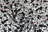 Swirled swatch It's a Mickey Thing fabric (white fabric with small tossed cartoon mickey heads collaged making various faces)