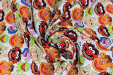 Swirled swatch licensed Muppets printed fabric in Muppets Cast (main heads on white: kermit, piggy, gonzo, fozzie, animal)