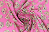 Swirled swatch licensed Muppets printed fabric in Miss Piggy (piggy heads on pink)