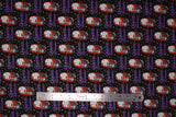 Flat swatch queen of screams fabric (black fabric with cartoon Sally character holding black cat "Queen of Screams" purple script beneath, repeated pattern with tiny tossed white and yellow dots and stars)