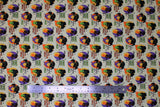 Flat swatch witchy attitude fabric (off white/pale yellow fabric with small oval badges with witch character silhouettes in purple, yellow, orange, black, green colourway and "to be young and beautiful again" "cursed with good looks" etc. text)