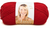 A ball of Lion Brand Vanna's Choice yarn on white background in shade cranberry (medium red)