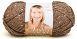 A ball of Lion Brand Vanna's Choice yarn on white background in shade barley (medium brown yarn with white and dark brown tweed like flecks)