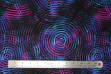 Flat swatch blue/purple fabric (black fabric with large groups of concentric circles in shades of blue, purple and dark pink allover)