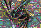 Swirled swatch Reve Laura Lancelle fabric (dark grey fabric with tossed full colour illustrative dream catchers allover)