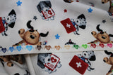 Raw hem swatch first aid friends fabric (white fabric with tossed cartoon dogs and cats in white, black, grey, tan colours with first aid kits red with white plus, medical charts, x-rays, etc. and tossed stars in grey, blue, red)