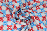 Swirled swatch bandage fabric (white fabric with alternating stripes of bandage x's made from blue and red bandages)