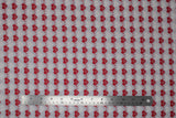 Flat swatch heartbeat fabric (grey fabric with alternating stripes of red hearts with red/white beat lines, and faint white hearts with beat lines)
