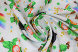 Swirled swatch St. Patrick's Day themed fabric in end of rainbow leprechauns and pots of gold on white