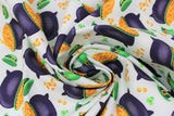 Swirled swatch St. Patrick's Day themed fabric in pots of gold and green hats tossed on white
