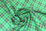 Swirled swatch St. Patrick's Day themed fabric in green plaid (green/black/yellow)