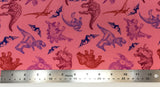 Flat swatch cretaceous dinosaurs printed fabric in pink (bubblegum pink fabric with tossed assorted dinosaurs from the cretaceous period in red, blue, purple, burgundy colours and tossed small mountains/volcanos)