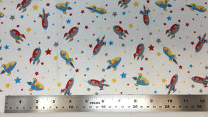 Group swatch cartoon rocketships and stars fabric in various colours