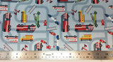Flat swatch cartoon emergency vehicles on road fabric in blue (pale blue fabric with dark pale blue road lines going all directions and full colour cartoon emergency vehicles on roads)