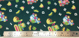 Flat swatch cartoon frogs, bears and cars fabric in green (dark forest green fabric with tossed white alphabet letters, yellow crowns, cartoon frog and bear heads, cartoon colourful vehichles with frogs and bears inside)