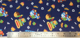 Flat swatch cartoon frogs, bears and cars fabric in navy (dark blue fabric with tossed white alphabet letters, yellow crowns, cartoon frog and bear heads, cartoon colourful vehichles with frogs and bears inside)