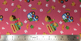 Flat swatch cartoon frogs, bears and cars fabric in pink (bubblegum pink fabric with tossed white alphabet letters, yellow crowns, cartoon frog and bear heads, cartoon colourful vehichles with frogs and bears inside)