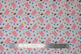 Flat swatch Candy Land fabric (white fabric with tossed "Candy Land" text in candy cane letters, tossed treats candy canes, fudgesicles, vanilla ice cream cones, candies in blue, pink, red)