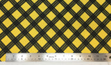 Flat swatch diagonal plaid printed fabric in yellow (yellow fabric with black diagonal thick square plaid lines)