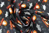 Swirled swatch Batteries Included fabric (black fabric with chucky heads and text allover)