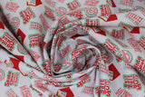 Swirled swatch santa claus is comin' to town fabric (white fabric with red "Santa Claus is Comin' to Town!" text in red with green outline, red envelopes with "Dear Santa" letter poking out, various red post markings)
