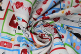 Swirled swatch happy helpers fabric (white fabric with cartoon dogs and cats with medical equipment in primary coloured frames, various medical emblems in full colour: scissors, syringe, red hearts with beat lines, pills, bottles, etc.)
