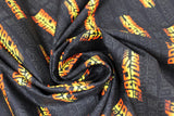 Swirled swatch Movie Title Logo fabric (black fabric with scattered 'back to the future' logo in movie font and orange/yellow colours)