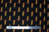 Flat swatch Movie Title Logo fabric (black fabric with scattered 'back to the future' logo in movie font and orange/yellow colours)