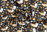 Swirled swatch Casper fabric (black fabric with tossed white Casper characters and tossed orange and white halloween candy with "Trick or Treat" text)