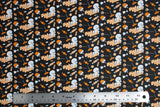 Flat swatch Casper fabric (black fabric with tossed white Casper characters and tossed orange and white halloween candy with "Trick or Treat" text)