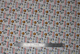 Flat swatch monster bff fabric (white fabric with small lines of halloween elements: yellow crescent moon, black bat, grey tombstone, grey hammer, werewolf look scratches, Frankenstein heads, mummy heads, werewolf heads, "Monsters are my BFFS" text)
