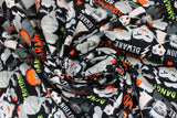Swirled swatch beware caution danger fabric (black fabric with busy collaged look halloween elements allover "Danger" "Caution" "Beware" "Warning" texts in white, orange, green, spooky halloween women and mummys, Frankenstein heads, etc.)