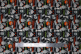 Flat swatch beware caution danger fabric (black fabric with busy collaged look halloween elements allover "Danger" "Caution" "Beware" "Warning" texts in white, orange, green, spooky halloween women and mummys, Frankenstein heads, etc.)