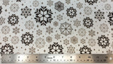 Flat swatch snowflake variety printed fabric in brown (tossed geometric look snowflakes in various sizes/styles in light to brown shades)