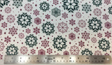 Flat swatch snowflake variety printed fabric in green (tossed geometric look snowflakes in various sizes/styles in red and green shades)