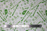 Flat swatch snow sports fabric in lime (white fabric with tossed snow sports emblems in lime green colour: skis, snowboards, goggles, hats, snowflakes, poles, boots)