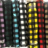 Bolts of buffalo plaid printed polar fleece in a variety of colours