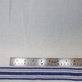 Flat swatch tea towelling material with blue stripe accents on white