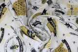 Swirled swatch bee's life fabric (white fabric with tossed assorted honey bee emblems and text, hives, bees, honeycombs, "Honey" "Pure Raw Honey" etc. in black/white/yellow gold)