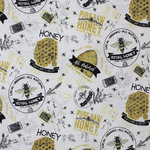 Square swatch bee's life fabric (white fabric with tossed assorted honey bee emblems and text, hives, bees, honeycombs, "Honey" "Pure Raw Honey" etc. in black/white/yellow gold)