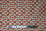 Flat swatch Eggshell fabric (off white fabric with small burnt orange ornate/victorian design allover)