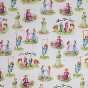 Square swatch Anne of Green Gables printed fabric (white fabric with repeated characters on grass patches: Anne in grass, Anne on swing, Anne and friend, Teacher, Anne and farm boy, "Anne of Green Gables" text)