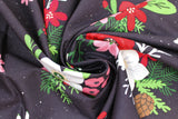 Swirled swatch Floral fabric (black fabric with tossed large cartoon style floral clusters with white, red, and pink floral heads and greenery, brown pinecones and tossed holly, scattered tiny white snow dots)