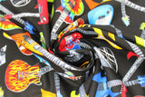 Swirled swatch tossed electric guitars fabric (black fabric with tossed/overlapping electric guitars in various styles and designs, brightly coloured guitars allover)